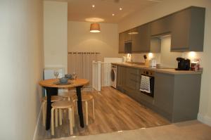 a kitchen with a table and chairs in a kitchen at 3 Endless Street in Salisbury