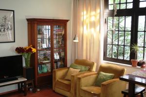 Casa Maria Obidos في أوبيدوس: غرفة معيشة مع كرسيين وتلفزيون