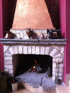 una chimenea de ladrillo con ollas y sartenes encima en Agriturismo San Martino, en Pozzuoli