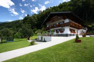 a building in the middle of a green field at Haus Lädeler in Schruns