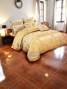 a bedroom with a bed and a tiled floor at Belcanto Apartments in Český Krumlov