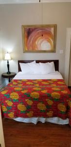 a bedroom with a bed with a colorful comforter at Inn on the Riverwalk in San Antonio