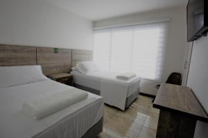 Postel nebo postele na pokoji v ubytování ARI Hotel