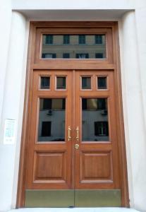 a wooden door with windows on a building at My Enchanting Roman Holiday in Rome