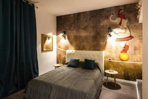a bedroom with a bed and a painting on the wall at Trevi & Pantheon Design Rooms in Rome