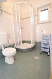a bathroom with a toilet and a shower at Apartments Gaspar in Cres