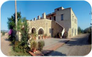 a large stone building with plants in front of it at Agriturismo PETRA LUCANA in Montescaglioso