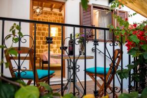 a balcony with two chairs and a table on a porch at Medieval Inn in Rhodes Town