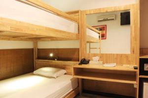 a room with two bunk beds and a desk at Hotel Karthi Kuta in Kuta +49 photos