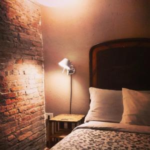 a bedroom with a bed and a lamp on a table at Corte di Maggio B&B in Imola