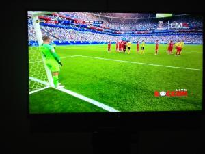a tv screen showing a soccer game on a field at Marie'z Villa in Tuktuk Siadong