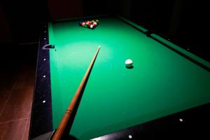 a green pool table with a ball on it at Hotel Casa Palacio in Montanejos