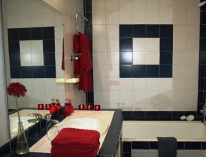 a bathroom with a tub and a sink with red candles at Casa Maria Obidos in Óbidos +60 photos