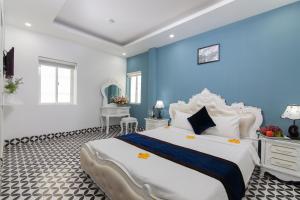 a bedroom with a large bed and blue walls at Hanoi Boutique House in Hanoi