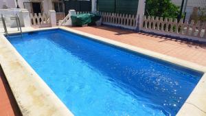 a swimming pool with blue water in front of a house at Anacasa Villa Faig Playa Burguera Terranova CH2500 in Oliva