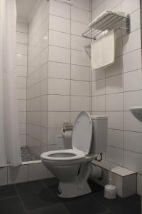 a bathroom with a toilet and a shower and a sink at Hotel Inju Hills in Astana