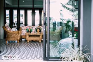 a living room with a couch and a table at Momda Resort @Ranong in Ranong