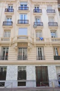 a building with a clock on the side of it at Le Charme-35 in Nice