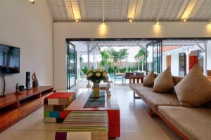 a living room with a couch and a table at Villa Khaizan in Canggu