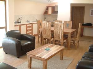 a living room with a table and chairs and a kitchen at Balchik English House in Balchik