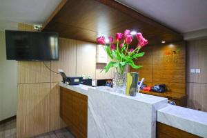 a vase of flowers on a counter in a room at The Baile in Jakarta