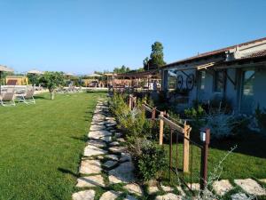 a stone path in front of a house at Agriturismo Sweet Cottage in Marina di Grosseto