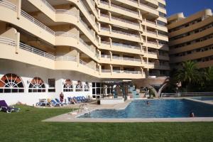 an apartment building with a swimming pool and a resort at Seastar in Vilamoura