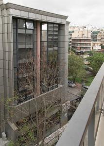 a building with a tree on the side of it at Penelope's Luxury Apartment in Athens