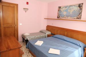 Postel nebo postele na pokoji v ubytování Hotel Da Remo