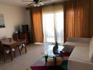 a living room with a couch and a table at Vacations in the Caribbean Paradise in Sosúa
