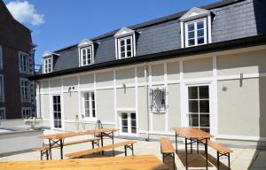 a building with picnic tables in front of it at La Maurianne in Spa