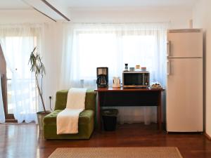 a kitchen with a desk and a chair and a refrigerator at AmurguluiBnB 3-Bedroom Bucegi Mountains Retreat in Buşteni +10 photos