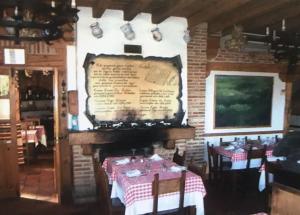 a dining room with tables and a large menu on the wall at Hospedaje Casa Mariano in Segovia +11 photos