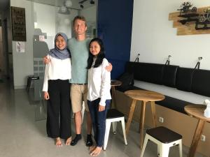 a man and two women posing for a picture at The Colour Hostel in Pontianak