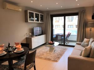 a living room with a couch and a table at Noray Swan in Puerto Calero