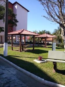 a park with a bench and a pavilion in the grass at Recanto do descanso in Iguaba Grande