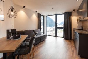 a living room with a couch and a table at Nauers in Kappl