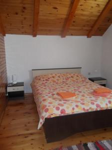 a bedroom with a bed in a room with wooden ceilings at Apartman Lucija in Žabljak