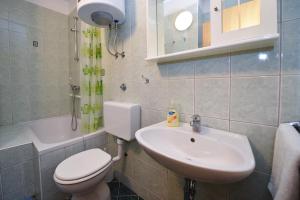 a bathroom with a toilet and a sink at Apartments Luaniva 50m from the see in Novalja +91 photos
