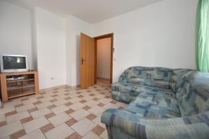 a living room with a couch and a television at Apartments Luaniva 50m from the see in Novalja