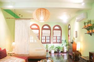 a living room with a staircase and some windows at iRoHa Garden Hotel & Resort in Phnom Penh