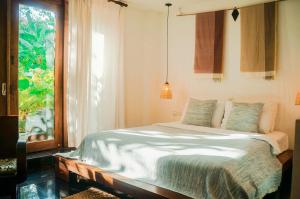 a bedroom with a large bed with a window at iRoHa Garden Hotel & Resort in Phnom Penh