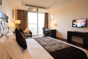 una camera d'albergo con letto e TV di Deventure Shimla Hills a Kandāghāt