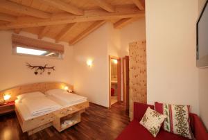 a bedroom with a bed in a room with wooden ceilings at Aparthotel Waidmannsheil in Kaprun