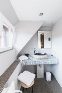 a bathroom with a sink and a mirror at Auberge au Boeuf in Sessenheim