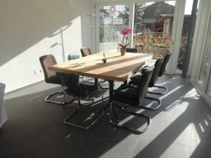 a wooden table and chairs sitting around a table in a room at Bed and Breakfast Prilly-Lausanne in Prilly