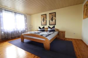 ツィノヴィッツにあるFerienwohnung Sonneのベッドルーム1室(木製ベッド1台、青い敷物付)