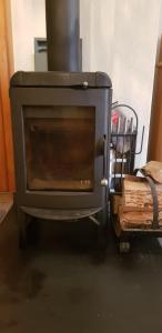 a black stove sitting in a room with at Chalet Spillstatt in Grindelwald