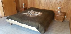 a bedroom with a bed with a blanket on it at Chalet Spillstatt in Grindelwald