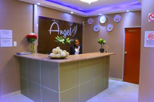 a man sitting at a counter in a salon at Angel Guest House in Johannesburg